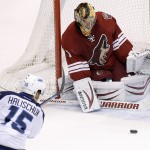 Phoenix Coyotes' Thomas Greiss (1), of Germany, makes a save on a shot by Winnipeg Jets' Matt Halischuk (15) during the third period of an NHL hockey game, Tuesday, April 1, 2014, in Glendale, Ariz. The Jets defeated the Coyotes in a shootout 2-1. (AP Photo/Ross D. Franklin)