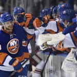 New York Islanders center Kael Mouillierat (48) celebrates his first NHL goal with teammates in the third period of an NHL hockey game against the Arizona Coyotes at Nassau Coliseum on Tuesday, Feb. 24, 2015, in Uniondale, N.Y. The Islanders won 5-1. (AP Photo/Kathy Kmonicek)