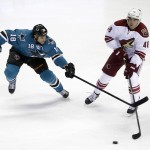 Arizona Coyotes' Jordan Martinook, right, is defended by San Jose Sharks' Mike Brown (18) during the first period of an NHL preseason hockey game Friday, Sept. 26, 2014, in San Jose, Calif. (AP Photo/Marcio Jose Sanchez)