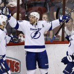 Tampa Bay Lightning's Ryan Callahan, middle, celebrates his goal against the Arizona Coyotes with teammates Mark Barberio (8) and Alex Killorn (17) during the second period of an NHL hockey game Saturday, Feb. 21, 2015, in Glendale, Ariz. (AP Photo/Ross D. Franklin)