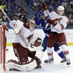 Arizona Coyotes goalie Mike Smith makes a blocker save on a shot by Tampa Bay Lightning left wing Jonathan Drouin as Coyotes' Connor Murphy defends during the second period of an NHL hockey game Tuesday, Oct. 28, 2014, in Tampa, Fla. (AP Photo/Chris O'Meara)