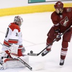 Carolina Hurricanes' Cam Ward (30) makes a save on a shot by Arizona Coyotes' David Moss (18) during the third period of an NHL hockey game Thursday, Feb. 5, 2015, in Glendale, Ariz. The Hurricanes defeated the Coyotes 2-1 in a shootout. (AP Photo/Ross D. Franklin)