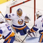 New York Islanders' Jaroslav Halak (41) makes a save against the Arizona Coyotes as Islanders' Frans Nielsen (51) and Calvin de Haan (44) look on during the second period of an NHL hockey game Saturday, Nov. 8, 2014, in Glendale, Ariz. The Islanders defeated Coyotes 1-0. (AP Photo/Ross D. Franklin)