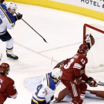 St. Louis Blues' David Backes (42) scores a goal, one of three during the second period, as he sends the puck past Arizona Coyotes' Mike Smith, back right, as Coyotes' Oliver Ekman-Larsson (23), of Sweden, Brandon McMillan (22) and Blues' T.J. Oshie (74) all look on during an NHL hockey game Tuesday, Jan. 6, 2015, in Glendale, Ariz. (AP Photo/Ross D. Franklin)