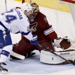 Arizona Coyotes' Mike Smith, right, makes a save on a shot by Tampa Bay Lightning's Ryan Callahan, left, during the second period of an NHL hockey game Saturday, Feb. 21, 2015, in Glendale, Ariz. (AP Photo/Ross D. Franklin)