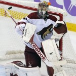 Arizona Coyotes goalie Mike Smith deflects a Minnesota Wild shot during the third period of an NHL hockey game, Thursday, Oct. 23, 2014, in St. Paul, Minn. The Wild won 2-0. (AP Photo/Jim Mone)
