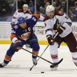 New York Islanders center John Tavares (91) chases Arizona Coyotes right wing Shane Doan (19) down ice in the third period of an NHL hockey game at Nassau Coliseum on Tuesday, Feb. 24, 2015, in Uniondale, N.Y. The Islanders won 5-1. (AP Photo/Kathy Kmonicek)