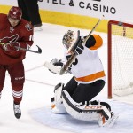 Philadelphia Flyers' Steve Mason, right, makes a save on a shot as Arizona Coyotes' Martin Erat (10), of the Czech Republic, jumps in front of the goalie during the first period of an NHL hockey game Monday, Dec. 29, 2014, in Glendale, Ariz. (AP Photo/Ross D. Franklin)
