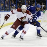 Arizona Coyotes center Martin Hanzal (11), of the Czech Republic, carries the puck past Tampa Bay Lightning defenseman Jason Garrison (5) during the first period of an NHL hockey game Tuesday, Oct. 28, 2014, in Tampa, Fla. (AP Photo/Chris O'Meara)