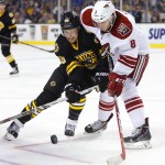 Arizona Coyotes' Tobias Rieder (8) and Boston Bruins' David Pastrnak battle for the puck during the second period of an NHL hockey game in Boston Saturday, Feb. 28, 2015. (AP Photo/Winslow Townson)