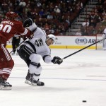 Arizona Coyotes defenseman Chris Summers (20), left, separates Los Angeles Kings defenseman Drew Doughty (8) from the puck in the first period during an NHL hockey game, Thursday, Dec. 4, 2014, in Glendale, Ariz. (AP Photo/Rick Scuteri)