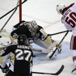 Phoenix Coyotes' Antoine Vermette (50) gets to a loose puck below Pittsburgh Penguins goalie Marc-Andre Fleury (29) for a first-period goal during an NHL hockey game in Pittsburgh, Tuesday, March 25, 2014. (AP Photo/Gene J. Puskar)

