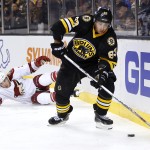Boston Bruins' Brad Marchand skates away from fallen Arizona Coyotes' Keith Yandle during the second period of an NHL hockey game in Boston Saturday, Feb. 28, 2015. (AP Photo/Winslow Townson)