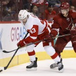 Detroit Red Wings' Darren Helm (43) tries to keep the puck away from Arizona Coyotes' Connor Murphy (5) during the first period of an NHL hockey game Saturday, Feb. 7, 2015, in Glendale, Ariz. (AP Photo/Ross D. Franklin)