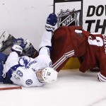Arizona Coyotes' Oliver Ekman-Larsson, right, of Sweden, flips over Tampa Bay Lightning's Nikita Kucherov (86), of Russia, during the third period of an NHL hockey game Saturday, Feb. 21, 2015, in Glendale, Ariz. The Lightning defeated the Coyotes 4-2.(AP Photo/Ross D. Franklin)