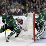 Dallas Stars goalie Kari Lehtonen (32), of Finland, minds the net as Brenden Dillon (4) clears the puck under pressure from Arizona Coyotes' Mikkel Boedker (89), of Denmark, in the second period of an NHL hockey game, Thursday, Nov. 20, 2014, in Dallas. (AP Photo/Tony Gutierrez)