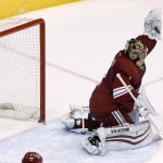 Phoenix Coyotes' Thomas Greiss, of Germany, gives up a goal to Minnesota Wild's Jared Spurgeon during the third period of an NHL hockey game, Saturday, March 29, 2014, in Glendale, Ariz. The Wild defeated the Coyotes 3-1. (AP Photo/Ross D. Franklin)