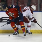 Florida Panthers' Erik Grudbanson (44) and Arizona Coyotes' Sam Gagner (9) battle for the puck during the first period of an NHL hockey game in Sunrise, Fla., Thursday, Oct. 30, 2014. (AP Photo/J Pat Carter)
