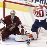 Arizona Coyotes' Mike Smith (41) makes a save on a shot by Florida Panthers' Sean Bergenheim (20), of Finland, during the second period of an NHL hockey game Saturday, Oct. 25, 2014, in Glendale, Ariz. (AP Photo/Ross D. Franklin)