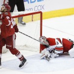 Arizona Coyotes' Lucas Lessio, left, grimaces after missing a shot against Carolina Hurricanes goalie Cam Ward during the shootout of an NHL hockey game Thursday, Feb. 5, 2015, in Glendale, Ariz. The Hurricanes defeated the Coyotes 2-1. (AP Photo/Ross D. Franklin)