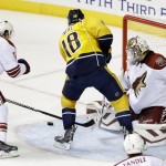 Arizona Coyotes goalie Devan Dubnyk (40) blocks a shot by Nashville Predators left wing James Neal (18) in the first period of an NHL hockey game Tuesday, Oct. 21, 2014, in Nashville, Tenn. Defending at left is Shane Doan (19). (AP Photo/Mark Humphrey)