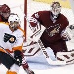 Arizona Coyotes' Devan Dubnyk (40) makes a glove save on a shot as Coyotes' Connor Murphy (5) defends against Philadelphia Flyers' Pierre-Edouard Bellemare (78) during the second period of an NHL hockey game Monday, Dec. 29, 2014, in Glendale, Ariz. (AP Photo/Ross D. Franklin)
