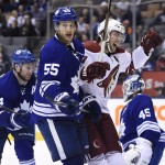 Arizona Coyotes' Martin Hanzal (11) celebrates a goal by teammate Sam Gagner for a 3-1 lead as Toronto Maple Leafs' Korbinian Holzer (55) looks away during the third period of an NHL hockey game Thursday, Jan. 29, 2015, in Toronto. (AP Photo/The Canadian Press, Frank Gunn)
