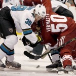 San Jose Sharks' Logan Couture (39) and Arizona Coyotes' Antoine Vermette (50) battle for the puck during the first period of an NHL hockey game Tuesday, Jan. 13, 2015, in Glendale, Ariz. (AP Photo/Ross D. Franklin)