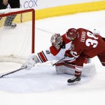 Arizona Coyotes' Lucas Lessio (38) hits the post against Carolina Hurricanes' Cam Ward (30) during the shootout of an NHL hockey game Thursday, Feb. 5, 2015, in Glendale, Ariz. The Hurricanes defeated the Coyotes 2-1. (AP Photo/Ross D. Franklin)