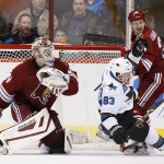 Arizona Coyotes' Oliver Ekman-Larsson (23), of Sweden, checks San Jose Sharks' Matt Nieto (83) to the ice in front of Coyotes goalie Devan Dubnyk, left, during the second period of an NHL hockey game Tuesday, Jan. 13, 2015, in Glendale, Ariz. The Sharks won 3-2. (AP Photo/Ross D. Franklin)