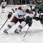 Arizona Coyotes left wing Mikkel Boedker (89), of Denmark, keeps the puck away from Minnesota Wild center Mikko Koivu (9), of Finland, during the second period of an NHL hockey game Saturday, Jan. 17, 2015, in St. Paul, Minn. (AP Photo/Hannah Foslien)
