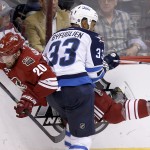 Winnipeg Jets' Dustin Byfuglien (33) checks Phoenix Coyotes' Chris Summers (20) into the boards during the third period of an NHL hockey game, Tuesday, April 1, 2014, in Glendale, Ariz. The Jets defeated the Coyotes 2-1 in a shootout. (AP Photo/Ross D. Franklin)