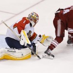 Arizona Coyotes' Joe Vitale (14) tries to redirect the puck in front of Florida Panthers' Roberto Luongo (1) during the second period of an NHL hockey game Saturday, Oct. 25, 2014, in Glendale, Ariz. (AP Photo/Ross D. Franklin)