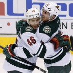 Minnesota Wild's Zach Parise (11) celebrates his goal against the Phoenix Coyotes with teammate Jared Spurgeon (46) during the third period of an NHL hockey game, Saturday, March 29, 2014, in Glendale, Ariz. The Wild defeated the Coyotes 3-1. (AP Photo/Ross D. Franklin)
