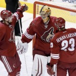 Phoenix Coyotes' Thomas Greiss, of Germany, is congratulated by teammates Mikkel Boedker (89), of Denmark, and Oliver Ekman-Larsson (23), of Sweden, for a win against the Dallas Stars as time expires in the third period of an NHL hockey game on Sunday, April 13, 2014, in Glendale, Ariz. The Coyotes defeated the Stars 2-1. (AP Photo/Ross D. Franklin)