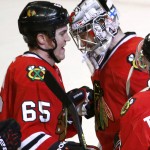 Chicago Blackhawks center Andrew Shaw (65) celebrates the Blackhawks' 6-1 win over the Arizona Coyotes with goalie Antti Raanta after an NHL hockey game Tuesday, Jan. 20, 2015, in Chicago. (AP Photo/Charles Rex Arbogast)
