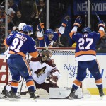 New York Islanders center John Tavares (91), center Ryan Strome (18), and center Anders Lee (27) celebrate defenseman Johnny Boychuk's goal as Arizona Coyotes goalie Mike Smith (41) reacts in the third period of an NHL hockey game Tuesday, Feb. 24, 2015, in Uniondale, N.Y. The Islanders won 5-1. (AP Photo/Kathy Kmonicek)