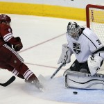 Los Angeles Kings goalie Martin Jones (31), right, makes the save on Arizona Coyotes center Tobias Rieder (8) in the third period during an NHL hockey game, Thursday, Dec. 4, 2014, in Glendale, Ariz. (AP Photo/Rick Scuteri)
