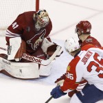 Arizona Coyotes' Mike Smith (41) makes a save on a shot by Florida Panthers' Jussi Jokinen (36), of Finland, as Coyotes' Michael Stone (26) also defends during the first period of an NHL hockey game Saturday, Oct. 25, 2014, in Glendale, Ariz. (AP Photo/Ross D. Franklin)
