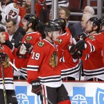 Chicago Blackhawk' Jonathan Toews (19) and Andrew Shaw (65) celebrate Toews' goal with teammates during the first period of an NHL hockey game against the Phoenix Coyotes on Tuesday, Jan. 20, 2015, in Chicago. Shaw would later score the Blackhawks' second goal (AP Photo/Charles Rex Arbogast)
