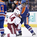Arizona Coyotes' B.J. Crombeen (44) fights Edmonton Oilers' Luke Gazdic (20) during the first period of an NHL hockey game in Edmonton, Alberta., on Monday, Dec. 1, 2014. (AP Photo/The Canadian Press, Jason Franson)