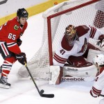 The puck hops over Chicago Blackhawks center Andrew Shaw's stick as he tries for a hat trick, as Arizona Coyotes goalie Mike Smith defends during the third period of an NHL hockey game Tuesday, Jan. 20, 2015, in Chicago. Shaw had two goals as the Blackhawks won 6-1. (AP Photo/Charles Rex Arbogast)
