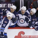 Winnipeg Jets' Andrew Ladd (16) celebrates his shootout goal against the Phoenix Coyotes with teammates Blake Wheeler (26), Evander Kane (9), Matt Halischuk (15), Eric O'Dell (58) and Jim Slater (19) during an NHL hockey game, Tuesday, April 1, 2014, in Glendale, Ariz. The Jets defeated the Coyotes 2-1. (AP Photo/Ross D. Franklin)