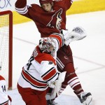 Carolina Hurricanes' Cam Ward gives Arizona Coyotes' B.J. Crombeen, rear, a shove during the first period of an NHL hockey game Thursday, Feb. 5, 2015, in Glendale, Ariz. (AP Photo/Ross D. Franklin)