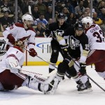 Pittsburgh Penguins' Tanner Glass (15) can't get his stick on a rebound in front of Phoenix Coyotes goalie Thomas Greiss (1) in the second period of an NHL hockey game in Pittsburgh, Tuesday, March 25, 2014. (AP Photo/Gene J. Puskar)
