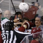  Dallas Stars' Antoine Roussel, middle, loses his helmet and gets a finger in his ear from Phoenix Coyotes' Derek Morris (53) as linesman Jay Sharrers (57) tries to break up the melee while Stars' Alex Chiasson, far left, and Colton Sceviour (22) and Coyotes' Keith Yandle (3) all look on during the third period of an NHL hockey game on Sunday, April 13, 2014, in Glendale, Ariz. The Coyotes defeated the Stars 2-1. (AP Photo/Ross D. Franklin)