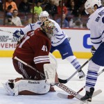 Arizona Coyotes goalie Mike Smith (41) makes the save agaiinst the Toronto Maple Leafs in the first periiod during an NHL hockey game, Tuesday, Nov. 4, 2014, in Glendale, Ariz. Maple Leafs James Van Riemsdyk is at right. (AP Photo/Rick Scuteri)