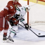  Dallas Stars' Antoine Roussel (21) is unable to get a shot off in front of the goal as Phoenix Coyotes' Mike Ribeiro (63) defends the play during the first period of an NHL hockey game on Sunday, April 13, 2014, in Glendale, Ariz. (AP Photo/Ross D. Franklin)