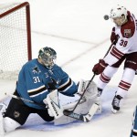 San Jose Sharks goalie Antti Niemi, left, of Finland, stops a shot attempt from Arizona Coyotes' Brendan Shinnimin (39) during the first period of an NHL preseason hockey game Friday, Sept. 26, 2014, in San Jose, Calif. (AP Photo/Marcio Jose Sanchez)