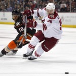 Anaheim Ducks right wing Devante Smith-Pelly, left, vies for the puck with Arizona Coyotes center Antoine Vermette during the third period of an NHL hockey game, Friday, Nov. 7, 2014, in Anaheim, Calif. The Coyotes won 3-2 in a shootout. (AP Photo/Mark J. Terrill)